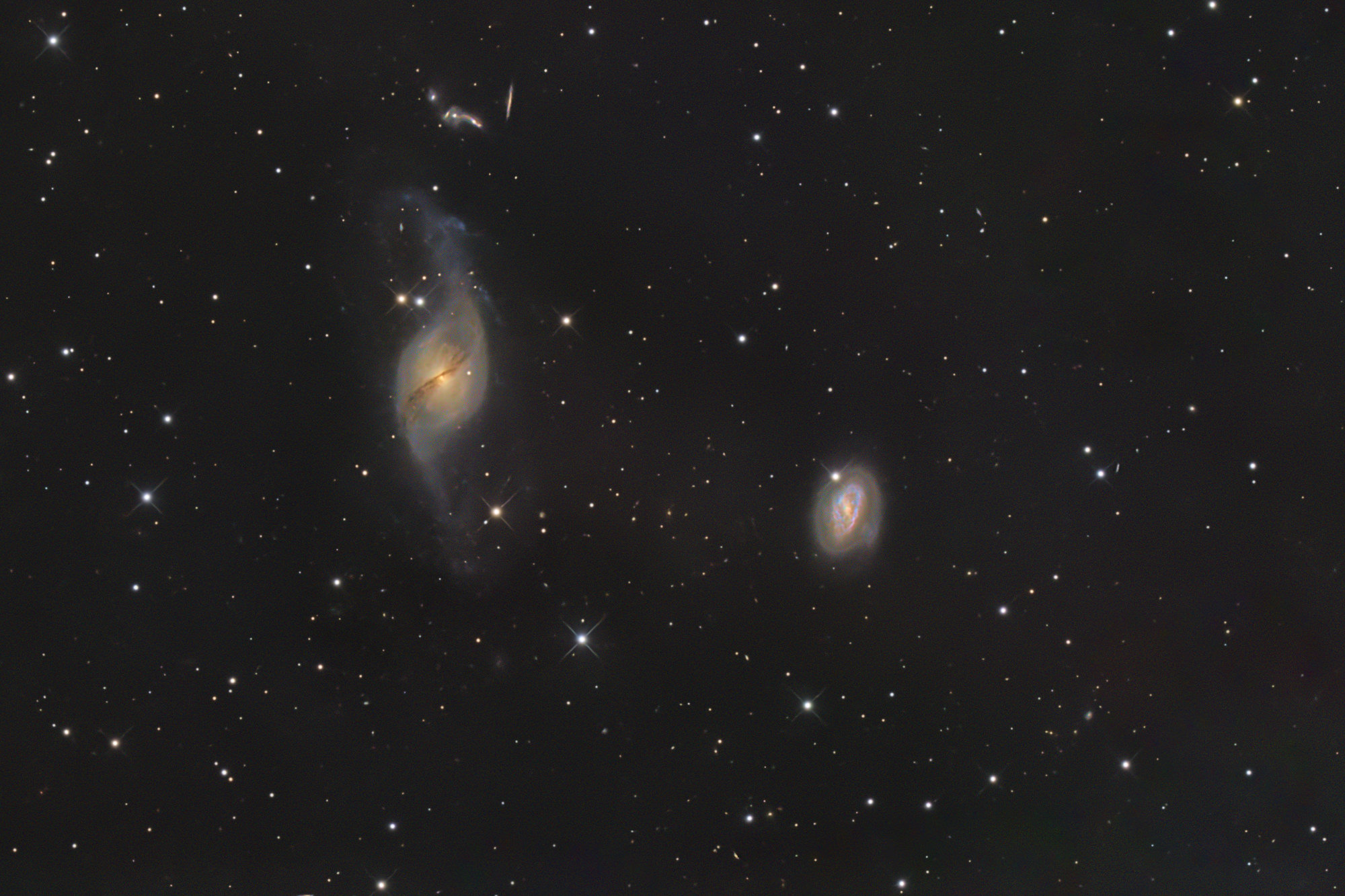 NGC 3718, also known as Arp 214, is located in the constellation Ursa Major (the Great Bear). Its distinctive S-shape is attributed to a gravitational interaction with the neighboring spiral galaxy NGC 3729.